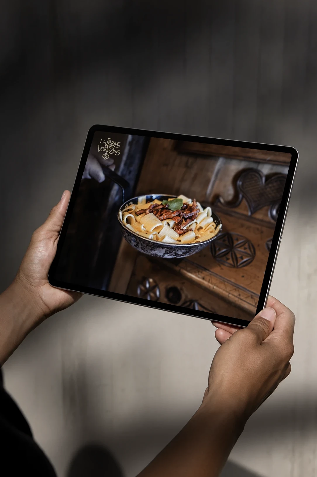 Site internet de La Ferme des V&ocirc;nezins pr&eacute;sent&eacute; sur tablette, avec une photographie de cuisine savoyarde.
