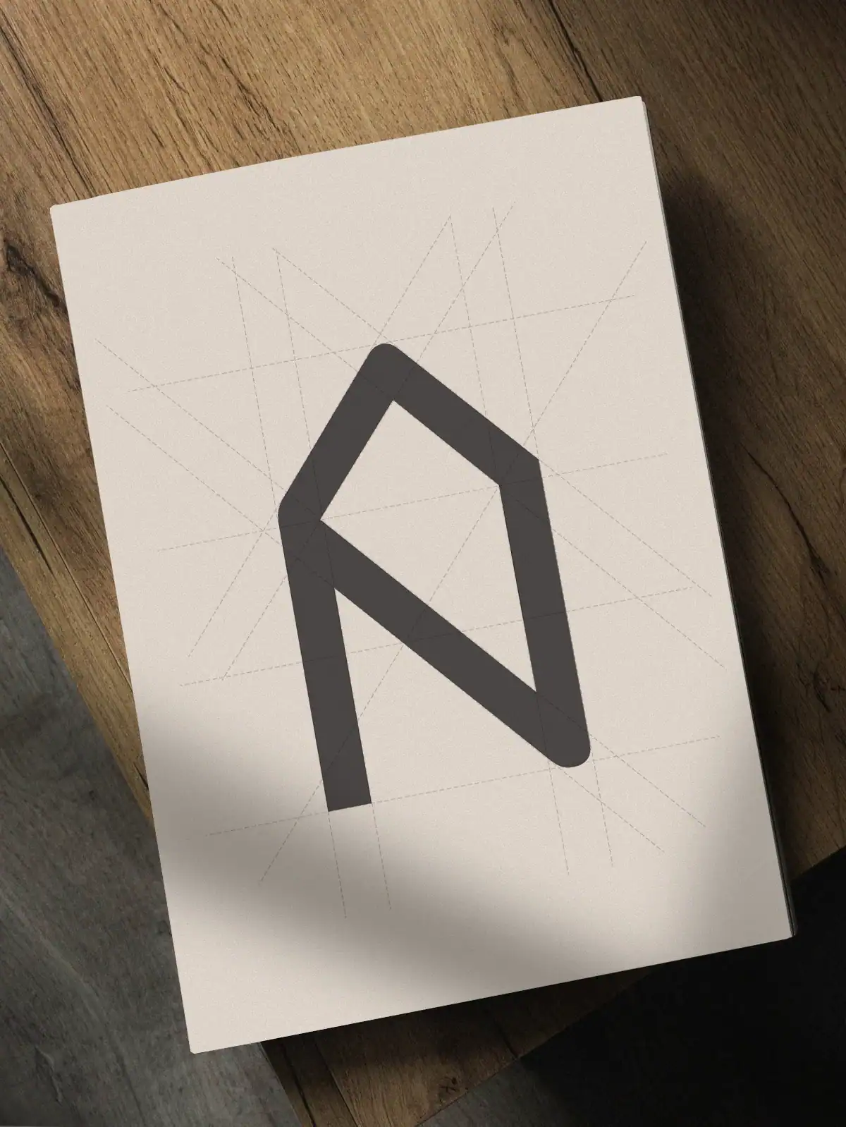 Construction g&eacute;om&eacute;trique du logo Eden Home inspir&eacute; d&rsquo;une maison en bois