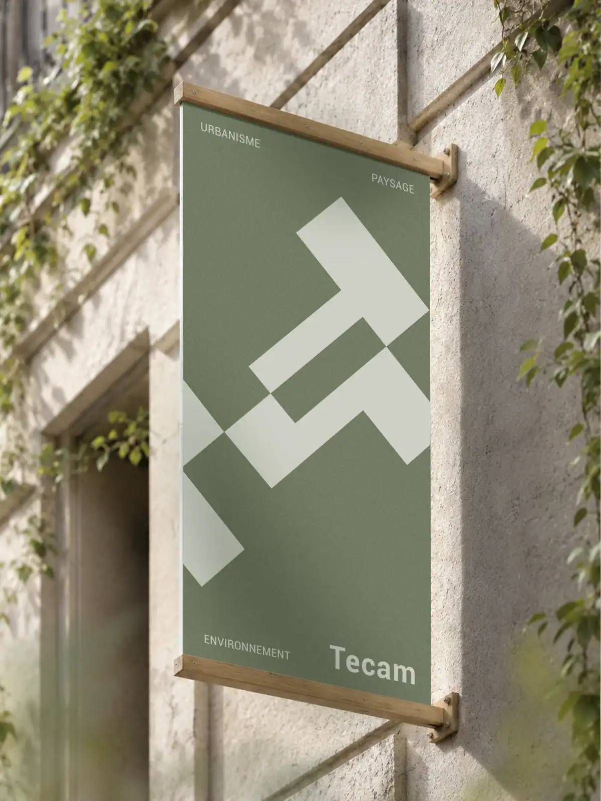Enseigne extérieure Tecam en bois clair présentant l’identité visuelle du bureau d’études en urbanisme, paysage et environnement.